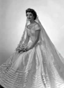 Jacqueline Bouvier The future first lady (and fashion icon) wore a voluminous ivory silk taffeta gown by the designer Ann Lowe when she married John F. Kennedy in 1953. A portrait neckline and wide, embellished skirt emphasized Jackie's small waist, and an heirloom lace veil, which originally belonged to her grandmother, completed the super-romantic ensemble.